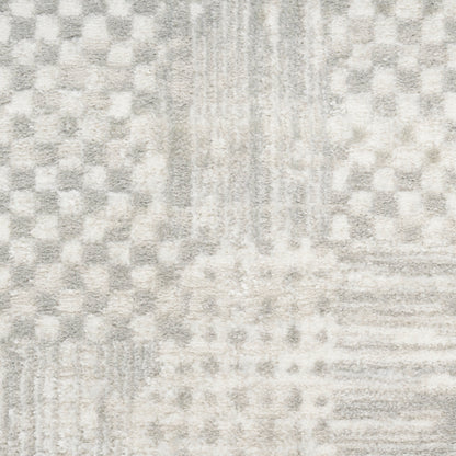 Gray and ivory geometric textured area rug with checker and stripe patterns; soft, plush, contemporary style.