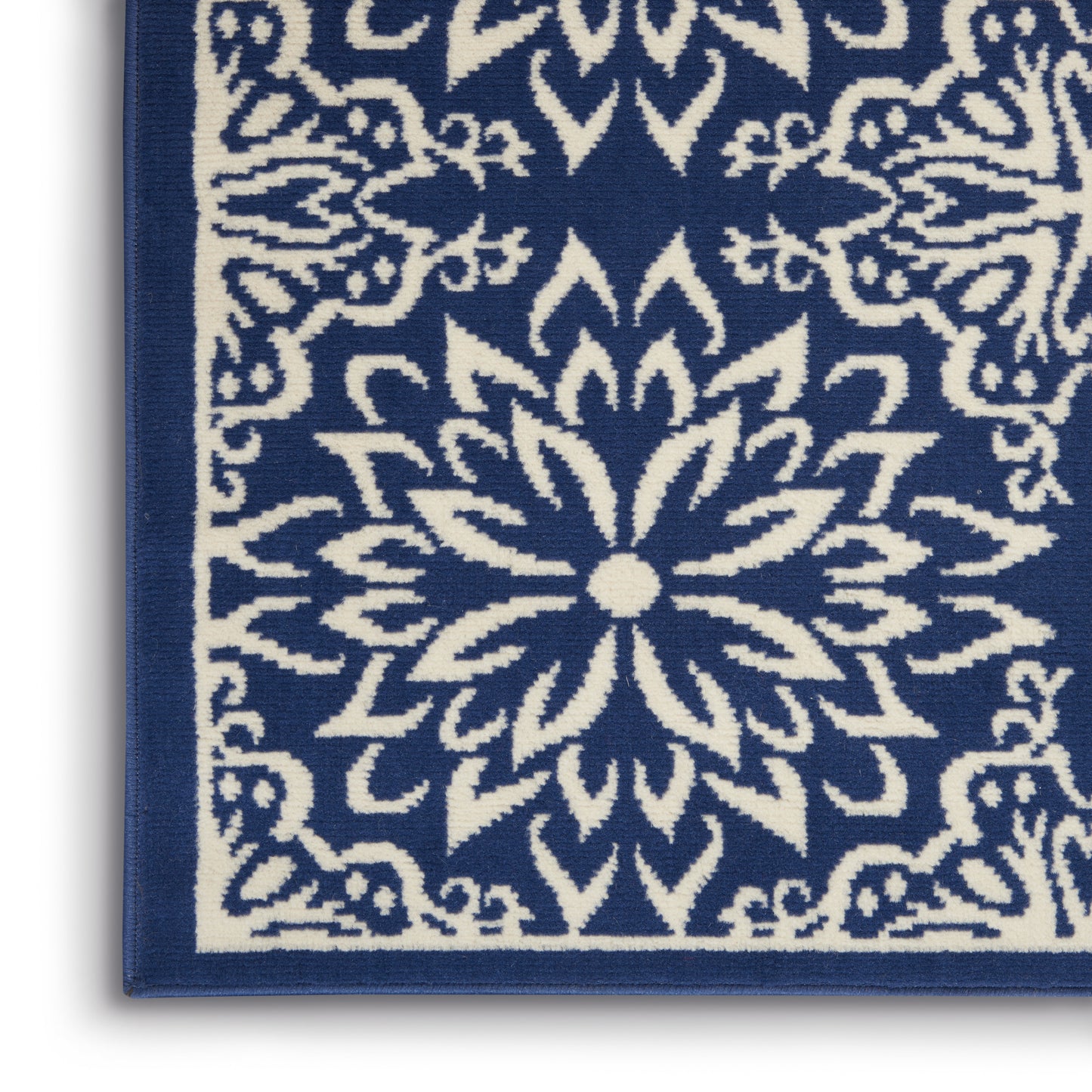 Blue & white textile rug with a central floral mandala pattern & matching border.