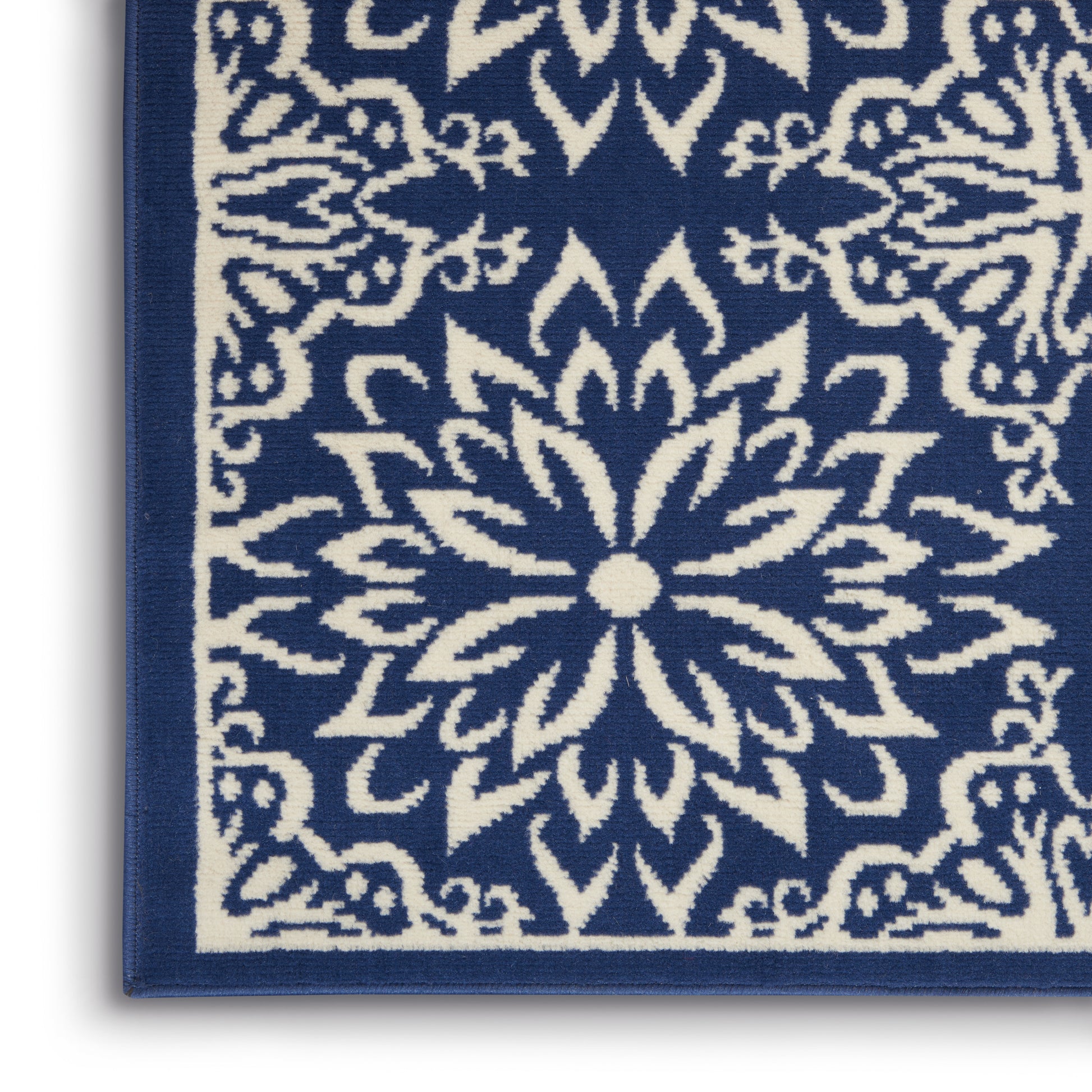 Blue & white textile rug with a central floral mandala pattern & matching border.