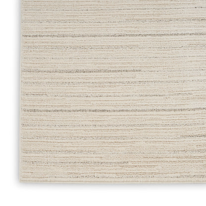 Beige flat-weave rug with subtle tan stripes; textured woven surface, rectangular, ideal for living room decor.