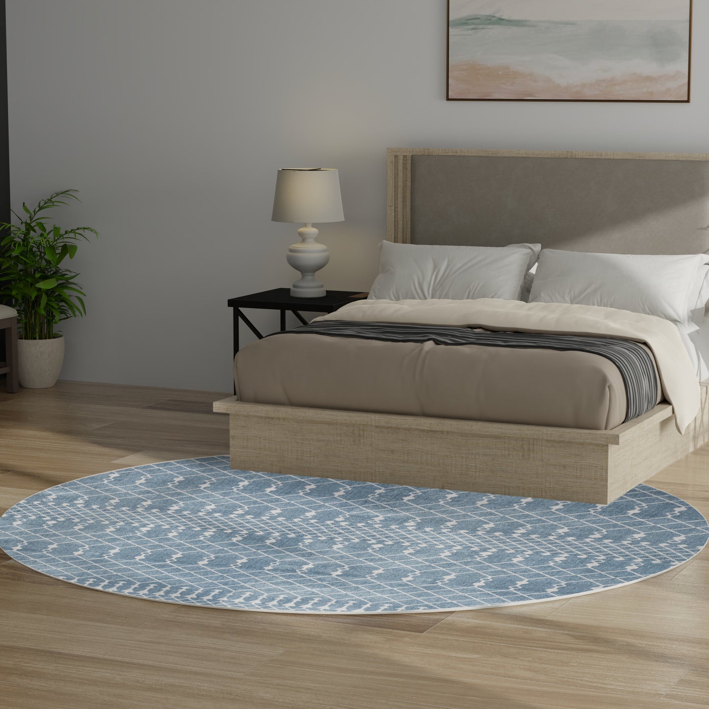 Round blue patterned area rug under beige platform bed with a gray upholstered headboard in a modern bedroom.