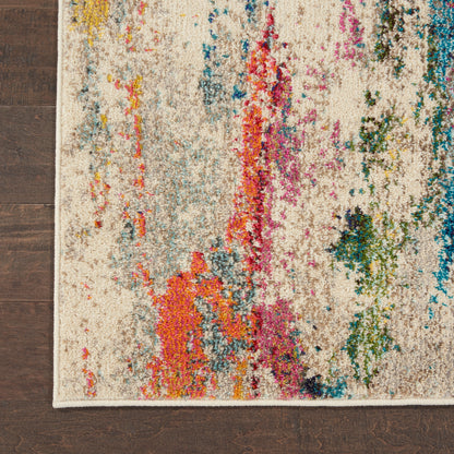 Beige abstract area rug with colorful splashes in orange, pink, blue, green on cream background, on dark wood floor.