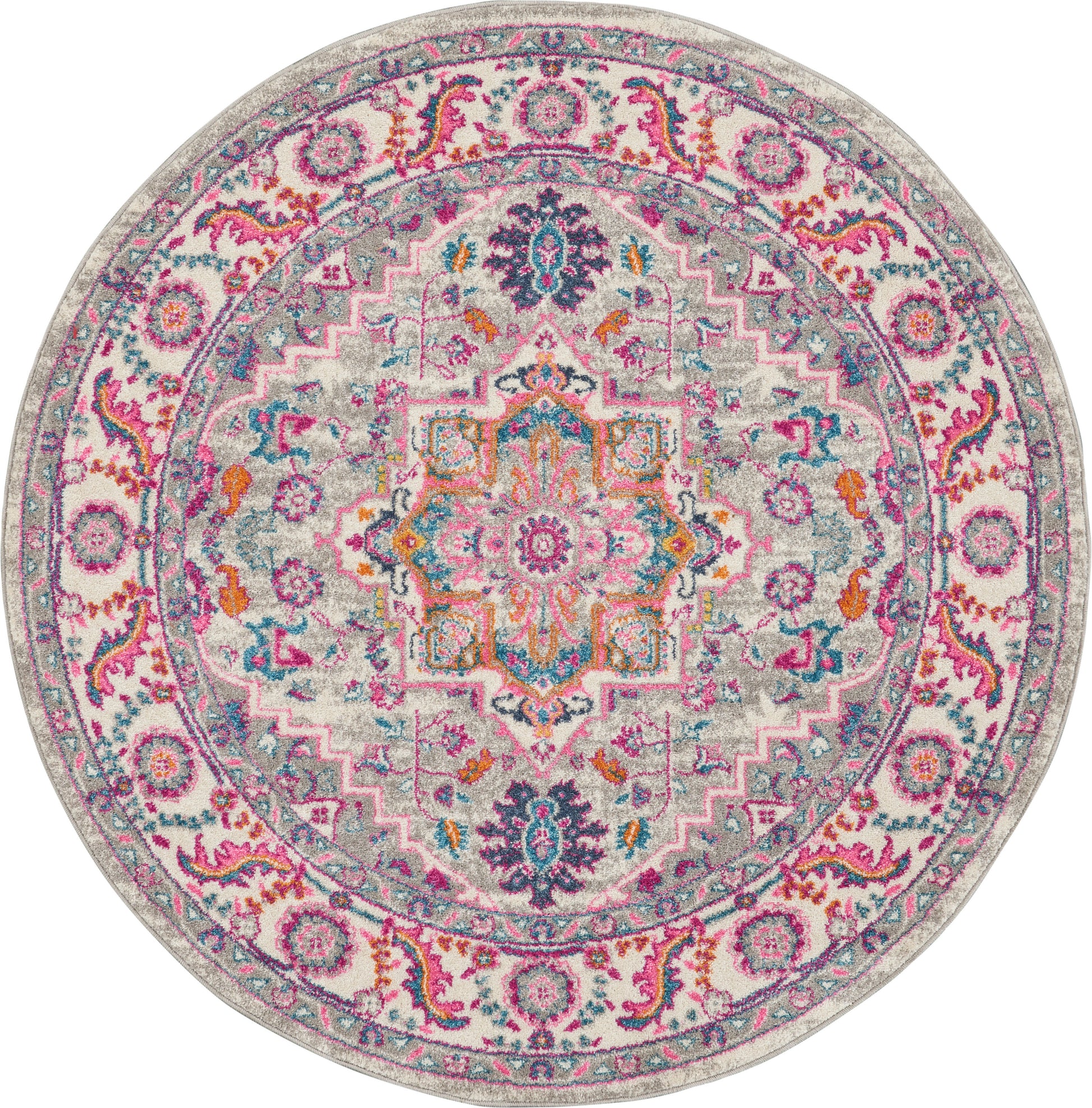 Round multicolor rug with ornate mandala medallion, pink, teal, orange and purple on a gray background.