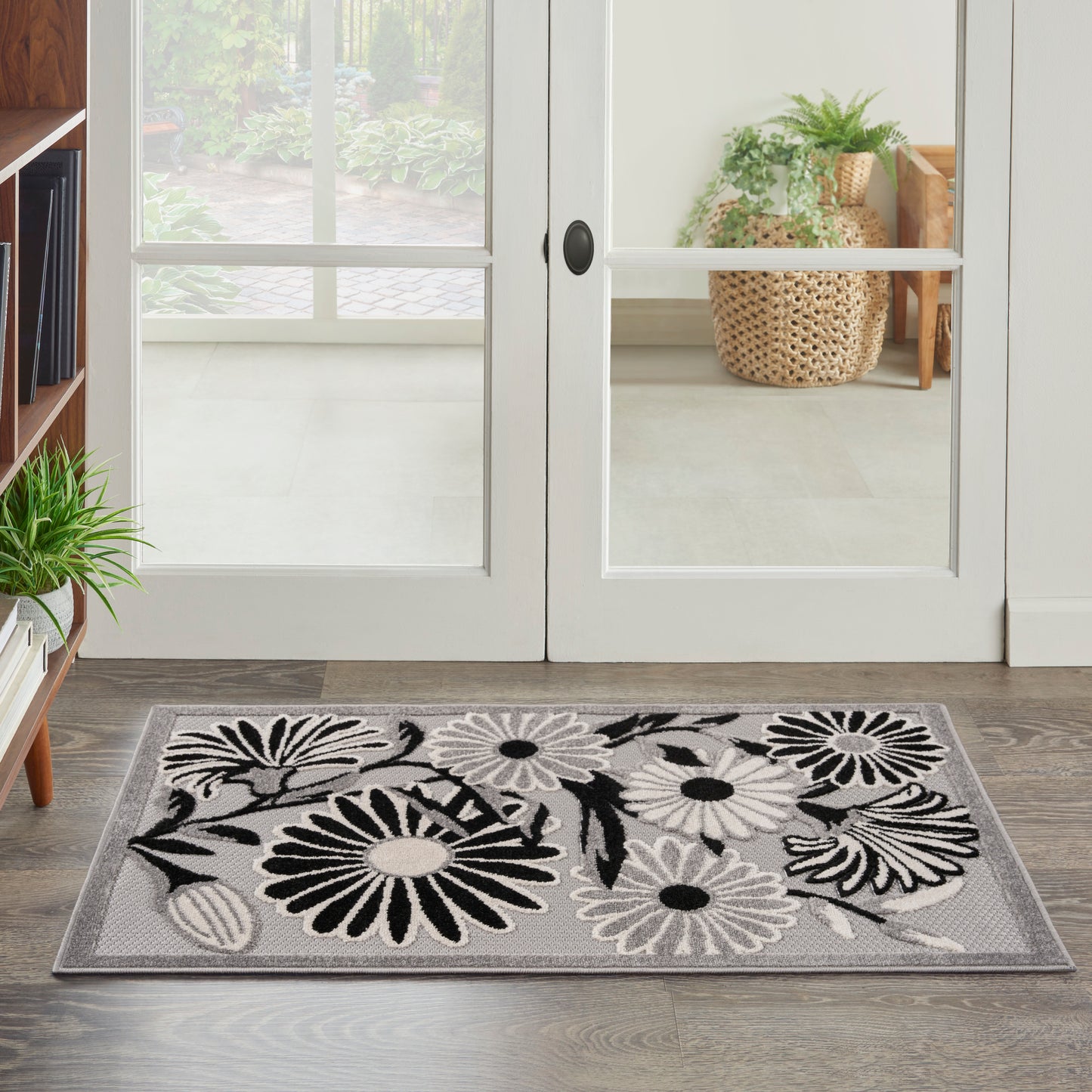 Rectangular grey floral doormat with black and white daisies, entryway mat for doorstep or foyer.