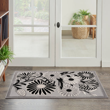Rectangular grey floral doormat with black and white daisies, entryway mat for doorstep or foyer.