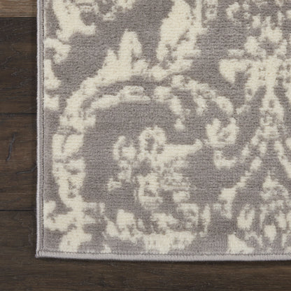 Rectangular runner rug with gray field and cream damask floral pattern, textured weave, bound edge.