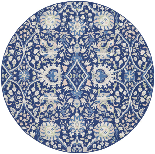 Round blue and white rug with dense floral vines, medallions and lattice motifs in a porcelain-inspired design.