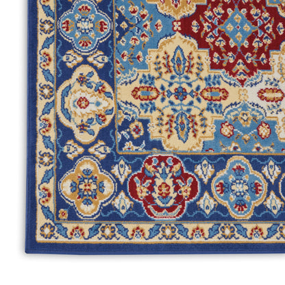 Close-up of an ornate blue and cream oriental rug with red accents and floral medallion patterns along a bordered edge.