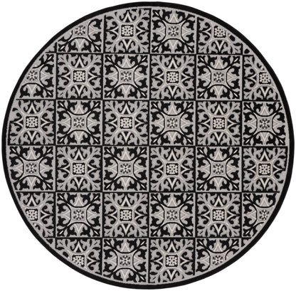 Round rug in black and gray with repeating square damask tile patterns and a dark border, decorative floor mat.