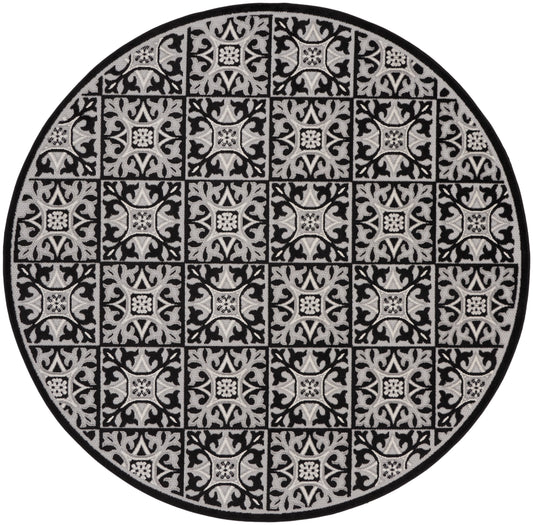 Round rug in black and gray with repeating square damask tile patterns and a dark border, decorative floor mat.