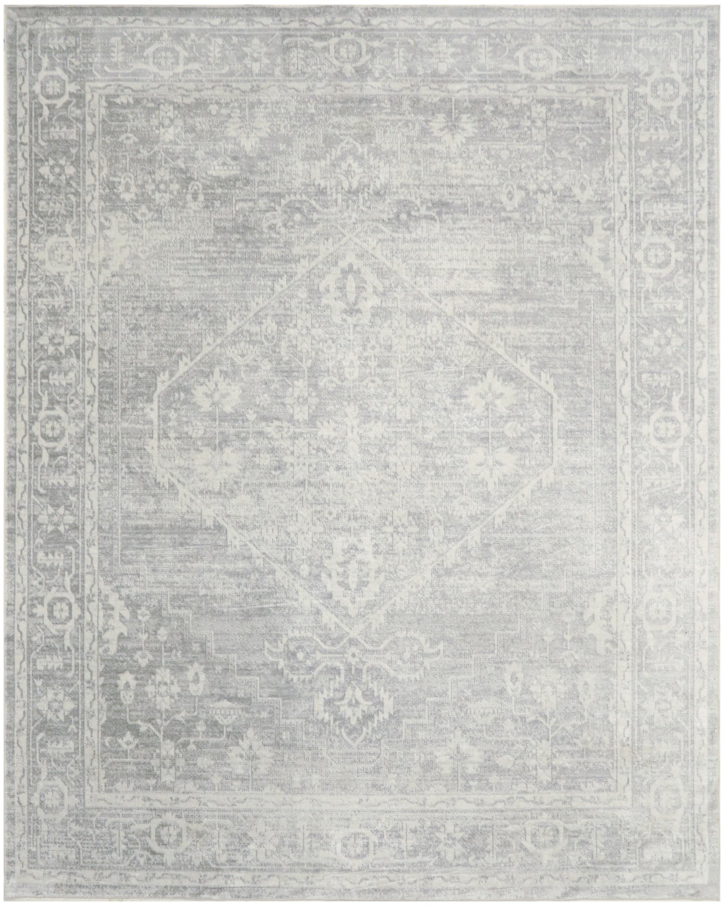Soft gray & off-white oriental-style area rug with a faded central medallion & ornate border.
