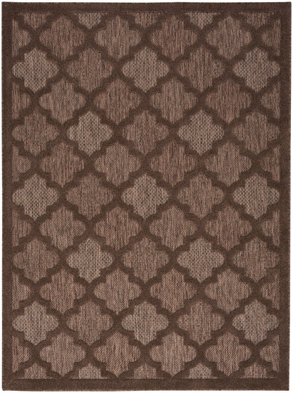 Brown area rug with dark brown lattice quatrefoil pattern on tan background.