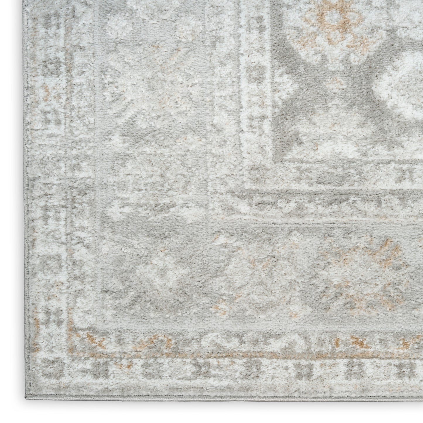Faded gray and ivory oriental-style area rug with beige accents and a distressed vintage border.