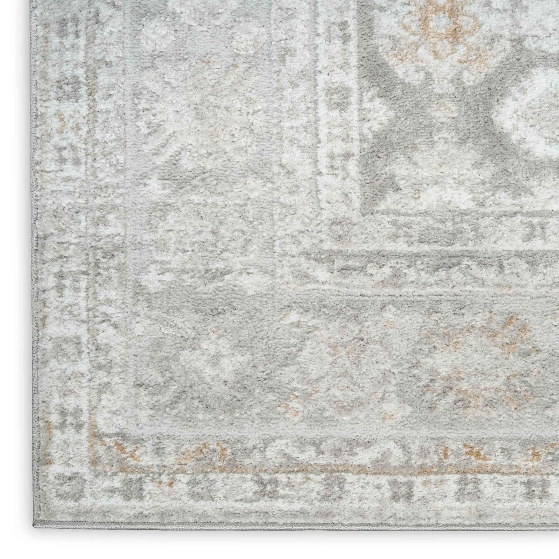 Faded gray and ivory oriental-style area rug with beige accents and a distressed vintage border.