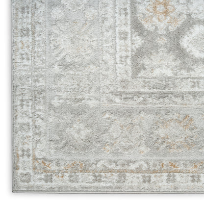 Faded gray and ivory oriental-style area rug with beige accents and a distressed vintage border.