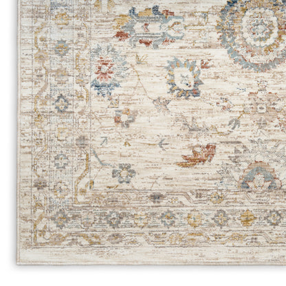 Cream distressed oriental rug with pale blue, gold and grey floral motifs and decorative border.