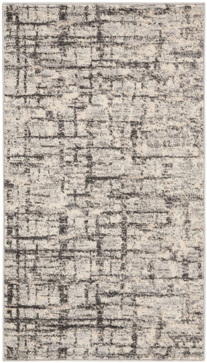 Rectangular abstract distressed rug in beige and charcoal gray with muted texture for modern neutral decor.