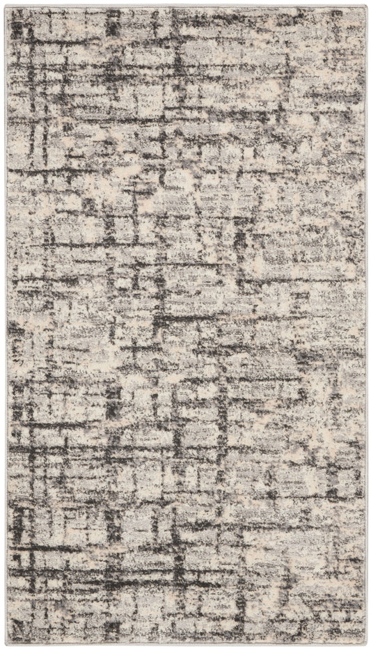 Rectangular abstract distressed rug in beige and charcoal gray with muted texture for modern neutral decor.