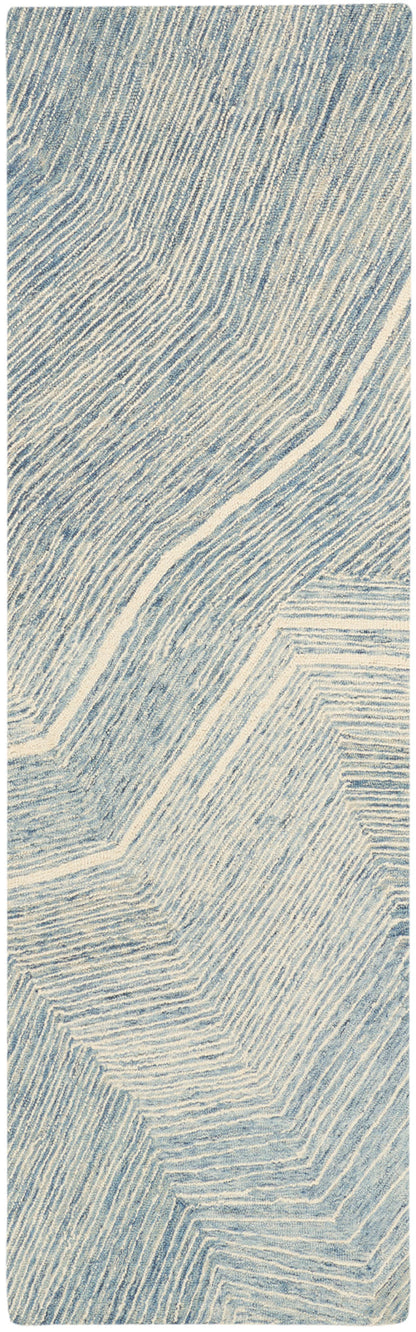 Blue-gray and cream abstract wood grain pattern with curved diagonal lines on a tall rectangular panel.