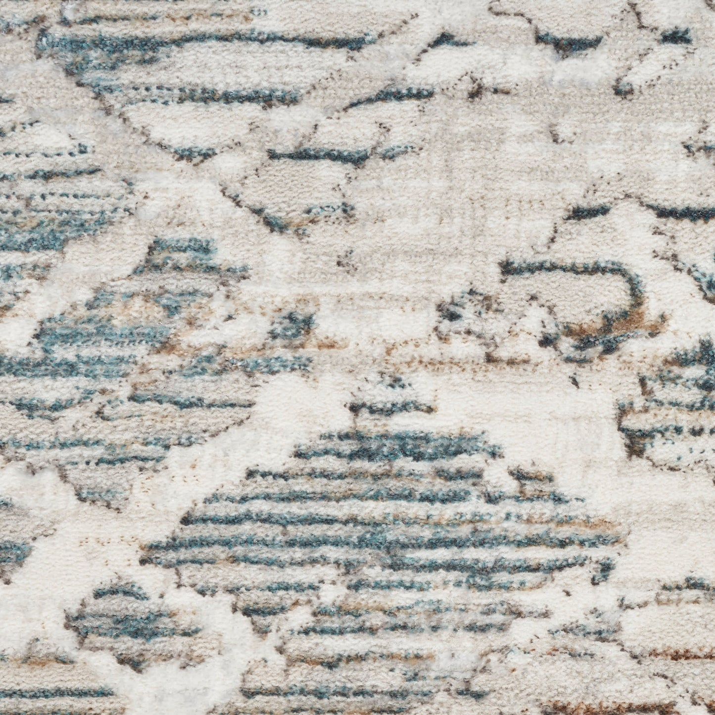 Abstract blue and cream area rug with plush pile and irregular geometric patterns.