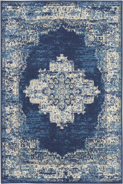 Distressed navy blue area rug with ivory and light blue accents, features a central geometric medallion and ornate border.