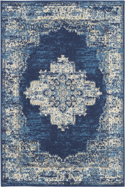 Distressed navy blue area rug with ivory and light blue accents, features a central geometric medallion and ornate border.