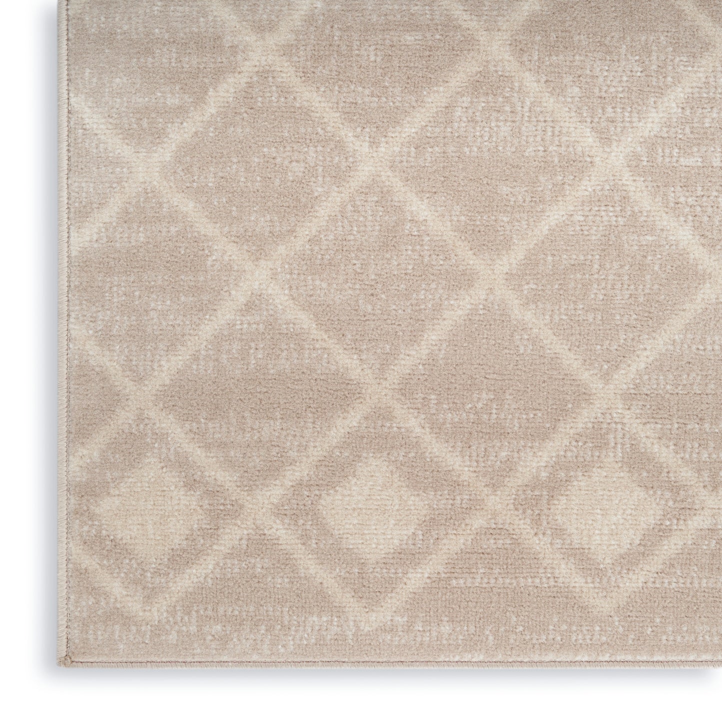 Beige plush area rug with a subtle geometric diamond lattice pattern; rectangular shape, soft and textured.