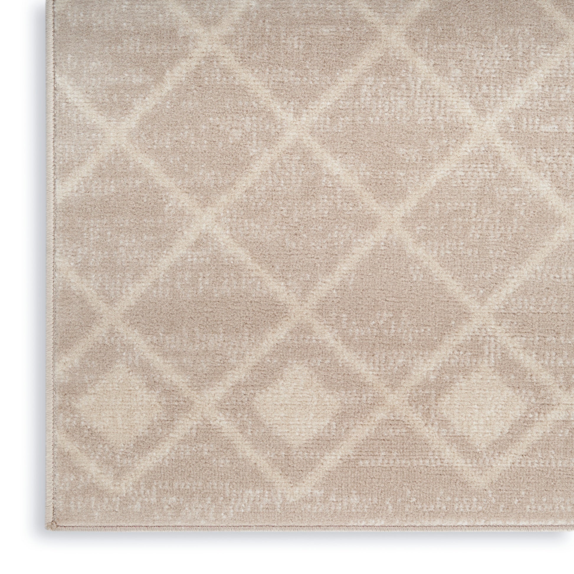 Beige plush area rug with a subtle geometric diamond lattice pattern; rectangular shape, soft and textured.