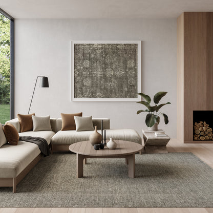 Vintage 5' x 8' rug in a neutral living room setting with a beige sectional, wooden coffee table, abstract wall art, floor lamp, plant, and fireplace.