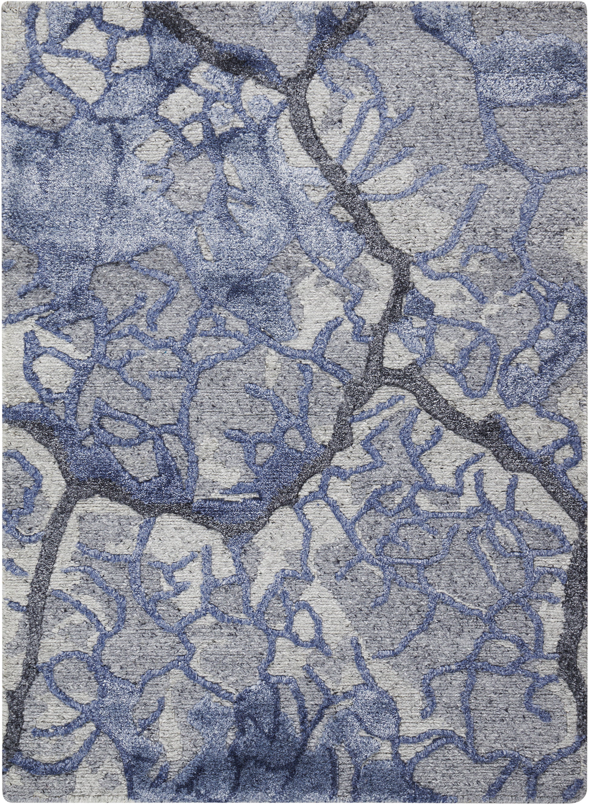 Blue-gray abstract rug with irregular branching lattice pattern and soft woven texture.