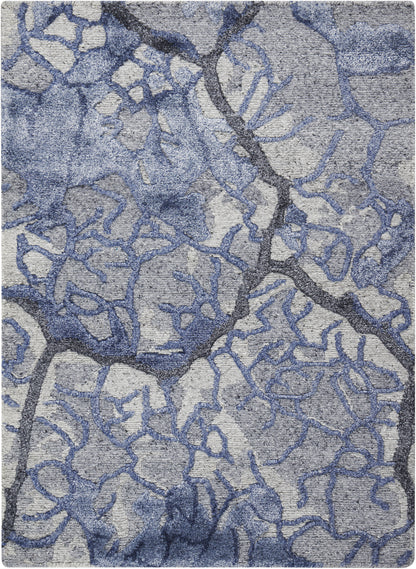 Blue-gray abstract rug with irregular branching lattice pattern and soft woven texture.