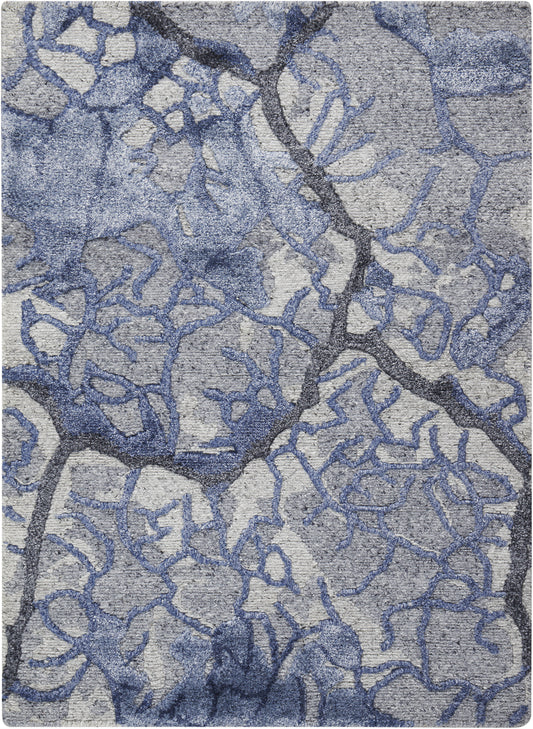 Blue-gray abstract rug with irregular branching lattice pattern and soft woven texture.