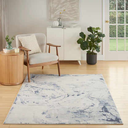 Mid-century armchair with light upholstery beside a ribbed wooden side table, blue abstract rug, white cabinet, & large potted plant.