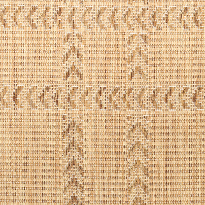Close-up of beige woven natural fiber textile with chevron/diamond pattern; rustic neutral rug texture.