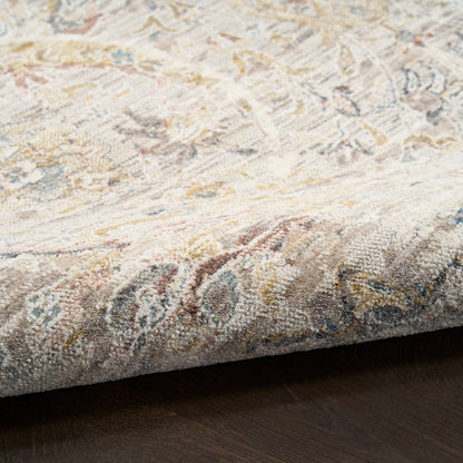 Close-up corner of a vintage-style woven runner rug with cream, beige, blue and gold tones on dark wood floor