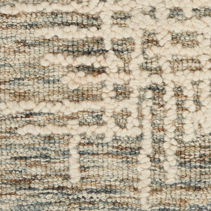 Cream beige and gray woven rug close-up with looped pile and geometric pattern.