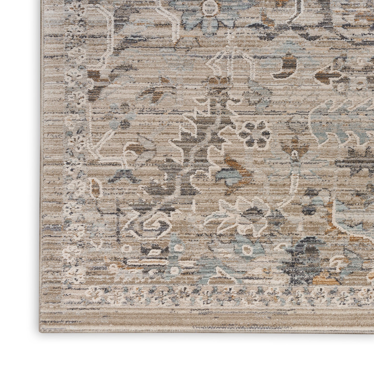 Soft beige rug with faded blue-grey floral pattern and bordered edge, vintage distressed look.