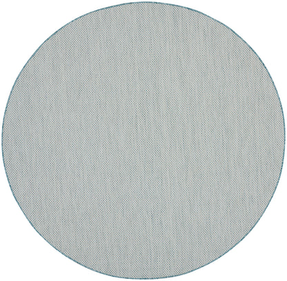 Round blue-gray rug with teal border and fine dotted texture, modern minimalist style, 8' round