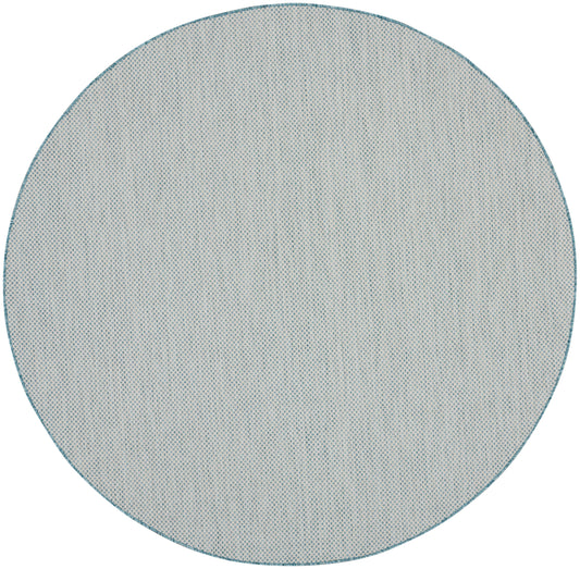 Round blue-gray rug with teal border and fine dotted texture, modern minimalist style, 8' round