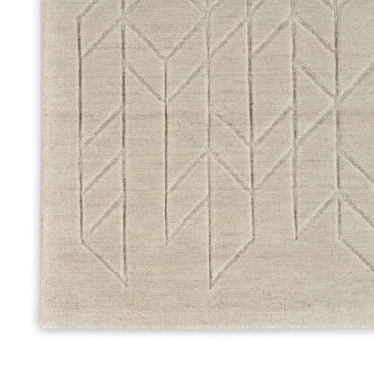Beige woven rug with raised geometric chevron pattern; neutral, modern decor for living spaces.
