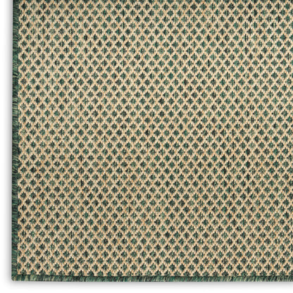Beige woven rug with teal diamond lattice pattern and dark green left border; textured floor covering.