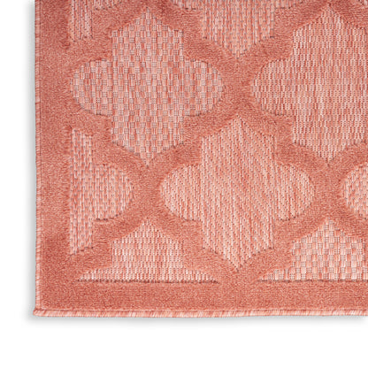 Coral pink rug corner with interlocking lattice diamond pattern and bordered edge