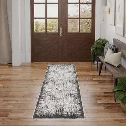 Dark wood double entry doors with grid glass panes; long gray distressed runner rug on oak hardwood, bench and greenery.