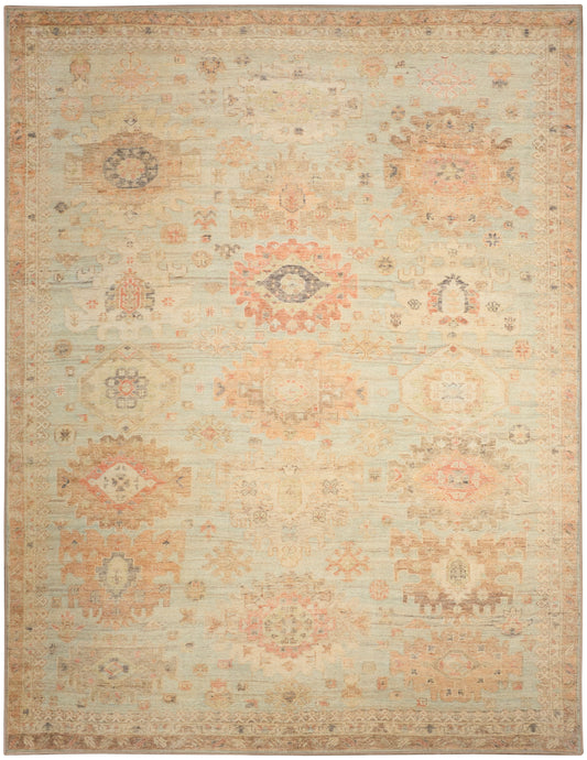 Distressed cream oriental rug with faded peach, blue and tan geometric floral medallions; vintage kilim-inspired design.