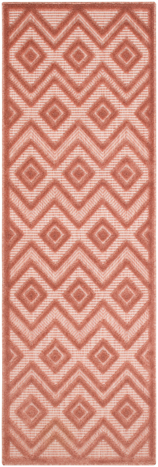 Terracotta pink geometric runner rug with diamond and chevron motifs, textured raised pile.