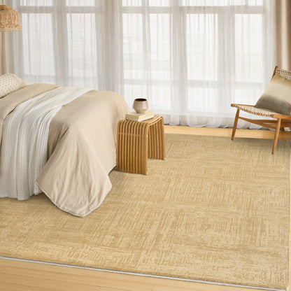 Neutral beige bedding with a light wood side table, woven rug, and a wooden chair by sheer-curtain windows.