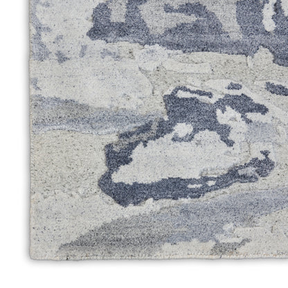 Rectangular plush area rug with abstract blue-gray and ivory pattern; modern high-pile for living room.