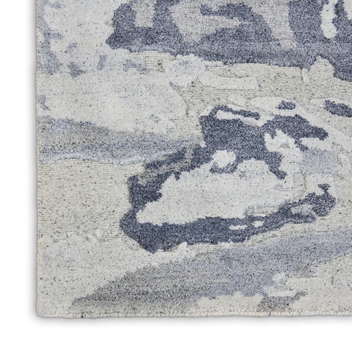 Abstract blue-gray area rug with plush pile; ivory backdrop and fluid pattern for modern decor.