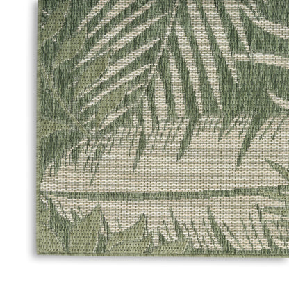 Woven outdoor rug with a green palm leaf pattern on a beige background; textured, rectangular.