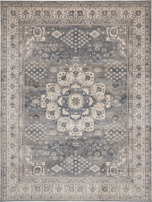 Blue-gray oriental rug with ivory central medallion, intricate floral border; distressed vintage look for living room decor.